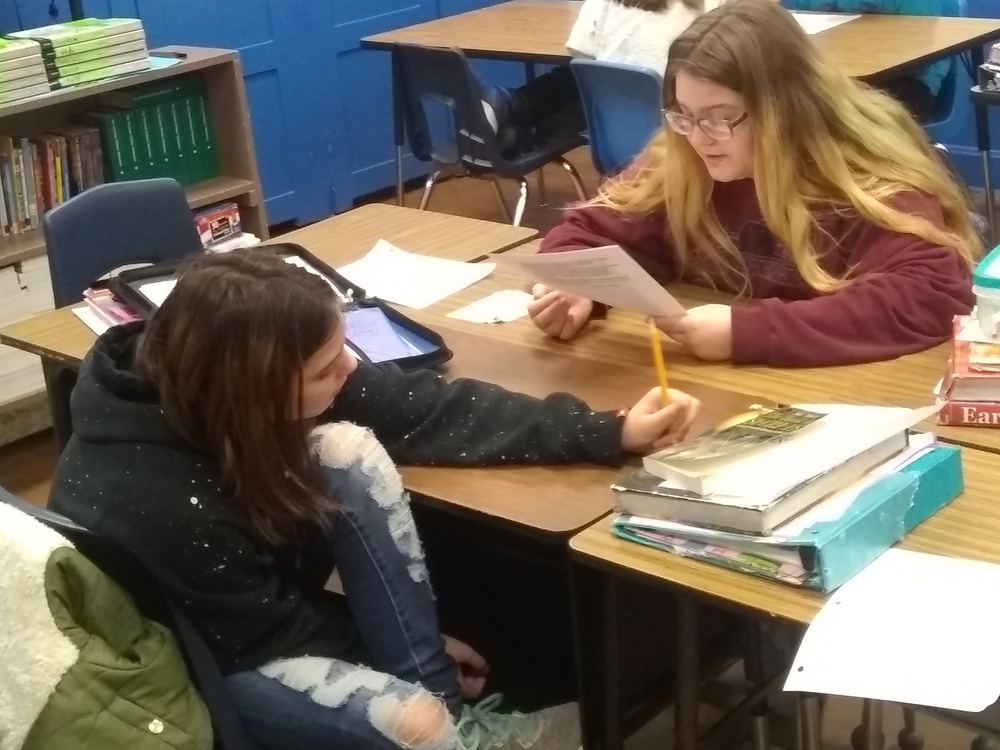 6th Grade students working in small groups.